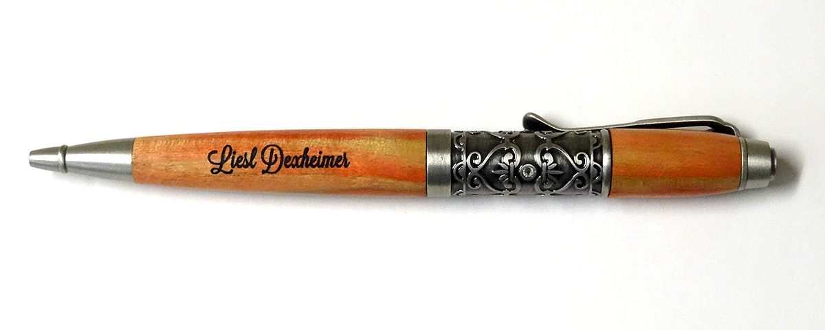 Custom flame box elder twist pen with engraving and color filled lettters.