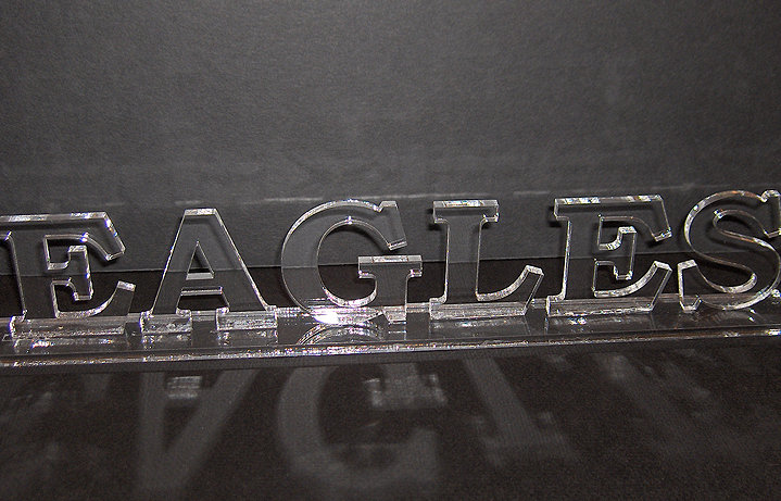 Laser cut acrylic letters adhered to acrylic bottom